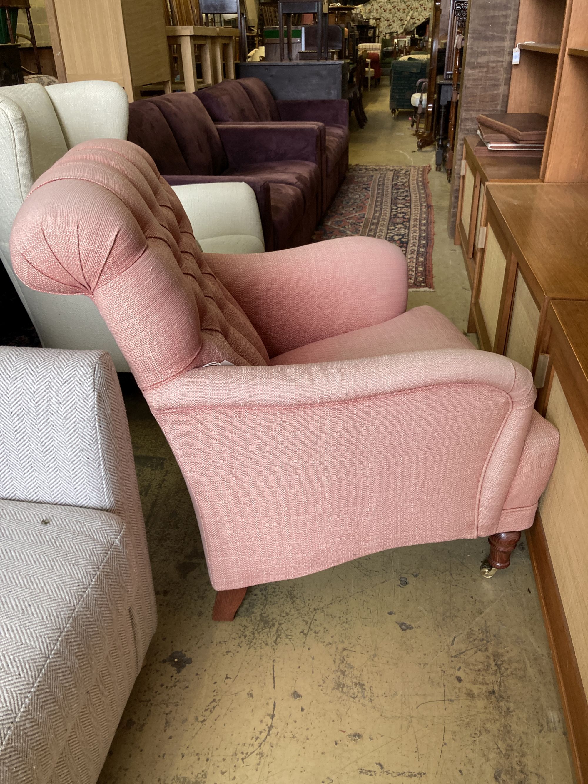 A contemporary buttoned upholstered armchair, length 80cm, depth 90cm, height 96cm